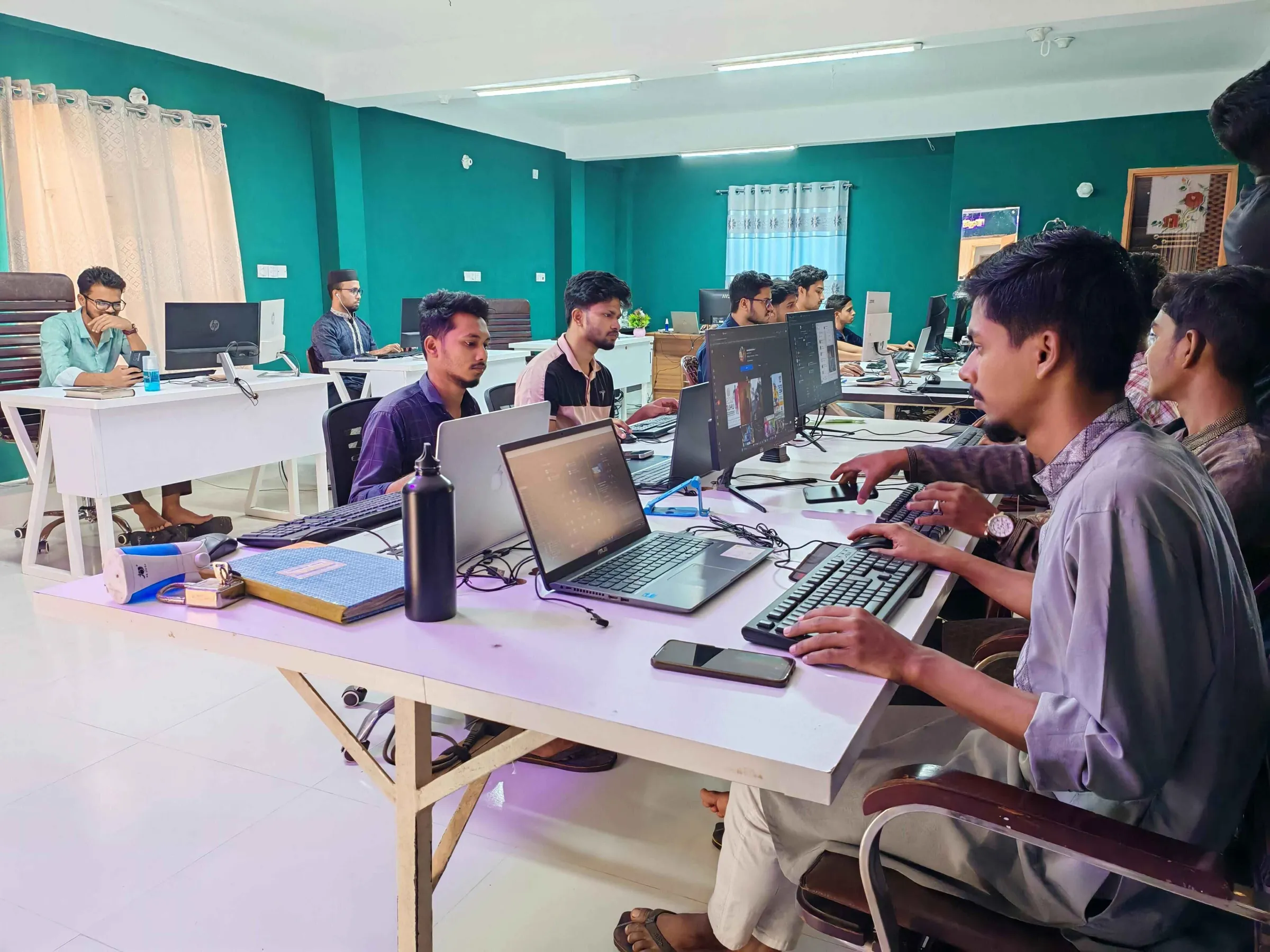 BD Commerce team working together with laptops and tablets